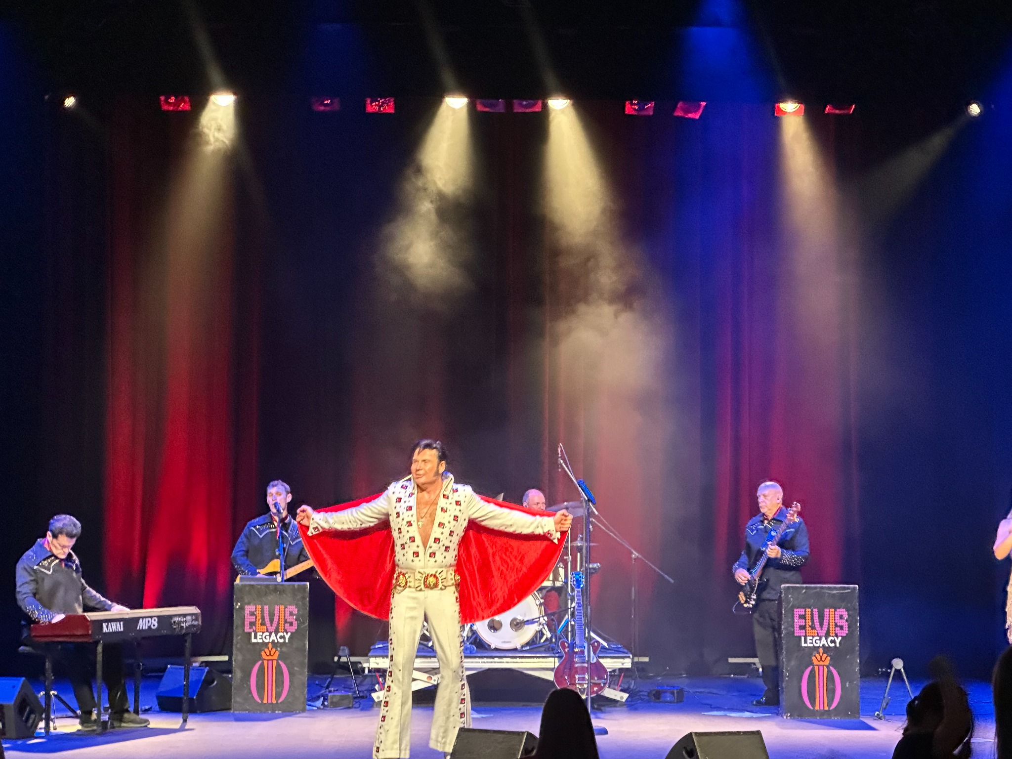 Mark Summers performing Elvis on stage with show lighting